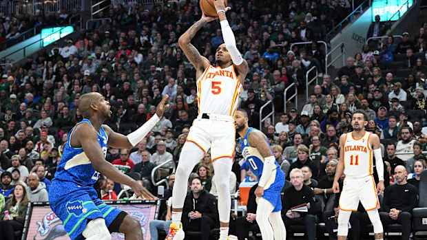 Atlanta Hawks guard Dejounte Murray (5) puts up a shot against Milwaukee Bucks forward Khris Middleton (22) in the second half at Fiserv Forum.